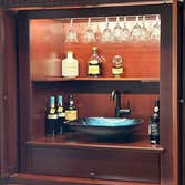 TV armoire converted into Wet Bar This was TV armoire that the customer wanted converted into a wet bar. We built a custom insert to accommodate a rack