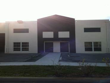 repainting warehouse in Hialeah Pressure washed, one coat of primer two coats of paint