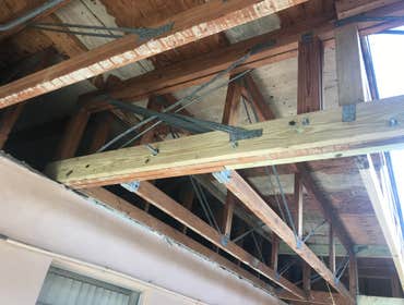 Photos by Dorin Building LLC #2 Structural damages, roof repairs, new stucco at soffits, painting, dumpster enclosure