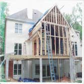 Photo(s) from Home Renovations & Remodeling Wall of windows great room addition, deck & cypress porch with stone water fall, pond & patio