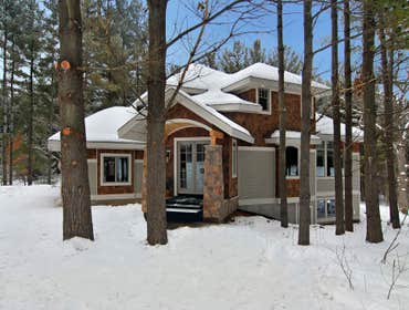 Lockridge Residence This new Transitional Custom Home was built on the owners heavily wooded lot and designed to maintain the woodsy feel while taking 