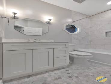 Geometric Bathroom Today we have an interesting bathroom with an angled wall and a geometric design scheme that turned out beautifully! We used a neutr