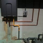 On -Demand water heater install ( Ours vs. Theirs ) Removal of tank-type water heater, run copper lines and electrical supply from attic, resize gas su