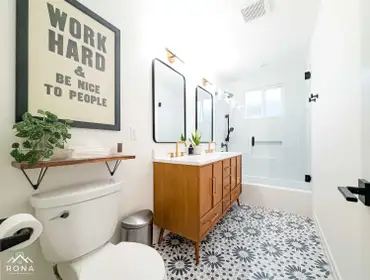 Hermosa Beach Bathroom Remodel We turned this Hermosa Beach bathroom into your coastal-inspired retreat! Picture a warm wood double vanity with brass h