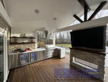 Photos by Farside Construction LLC #1 Newly constructed covered deck with standing seam cathedral style gable roof. Excavated and built a walk out egre