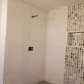 Ceramic tile shower with a vertical accent strip, Eagan, MN