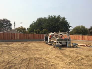 Retaining block wall with redwood fence on top