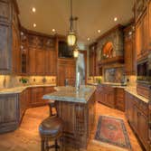 Custom Home with Inspiring Views DESCRIPTION
This home melds rich materials with soft, arching lines— resulting in an elegant but cozy feel throughout