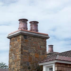 European Copper Pots on 5 chimneys. We designed, fabricated and installed custom copper flashing with 7 European Copper Pots for a luxury residence...