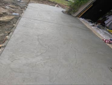 Photos by Colossal Concrete #2 New driveway with wrap around Old Granite Stamped Apron and entry, Broomed center and 1' Roman Slate borders
