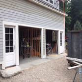 2 car garage door with entry way door Garage doors installed with entry way door.
Installed steps on side of garage leading up to a porch.