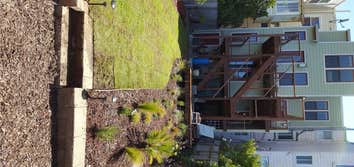 Potrero Backyard 12'x10' Redwood deck, Garden design and installation, Irrigation, Flagstone walkway, Kurapia sod installation.