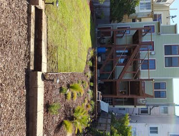 Potrero Backyard 12'x10' Redwood deck, Garden design and installation, Irrigation, Flagstone walkway, Kurapia sod installation.