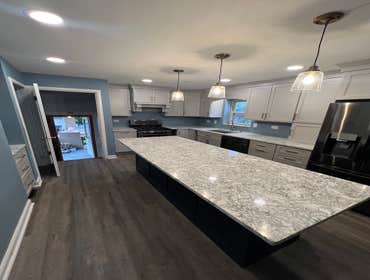 Photos by Cc&m Home Rehab #1 Full kitchen remodel with custom cabinets, quartz, and wall removal