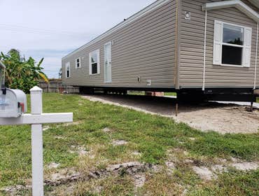 Photos by Blanchard's Mobile Home Removals and Transport Inc #1 New Clayton 16' X 76' Single wide Manufactured Home Spread Base Pad For Home, position 