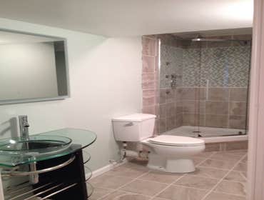 Built New Bathroom in Basement High End Bathroom Build. Shower includes multi jet body sprays and multi color lighted rain shower. Herringbone patter
