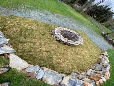 Photos by Madlandscape #5 This was a custom fire pit built with natural stone, build with a retaining wall behind it with lighting and gas lines undern