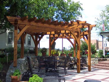 (2) Custom designed timber-framed pergola, timber-framed carport Each timber is hand carved to fit into the joining beam.