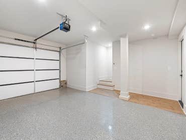 Finished garage at 1135 Delmas Ave, East Nashville: epoxy floor, modern opener, and mudroom style entry steps built by CJMC Build.
