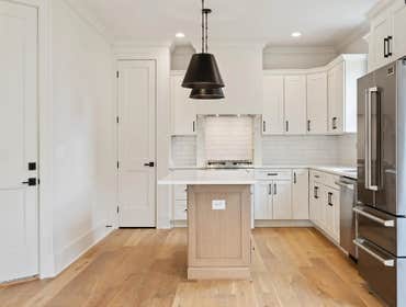Bright kitchen with shaker cabinets, quartz counters, and island workspace-CJMC Build, 2703 Bronte Ave, Nashville.