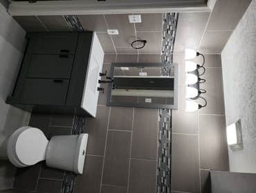 Photos by Magnum Home Services LLC #8 Condo conversion full rehab project! Beautiful bathrooms and kitchen.