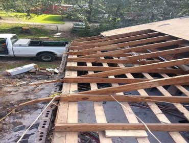Photos by Service Restoration Pros LLC #1 A tree fell through the roof of this 3 bedroom house during Hurricane Ida. It left several gaping holes and a