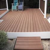 composite decking Customer had a brick patio that was on an uneven grade. We built a new composite deck with a vinyl railing system. Now they can have 