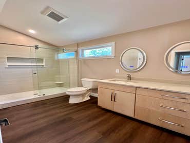 Photos by Lightship Development LLC #1 Complete remodel due to flood. Reconfigured master bathroom floor plan to accommodate over sized walk in shower.