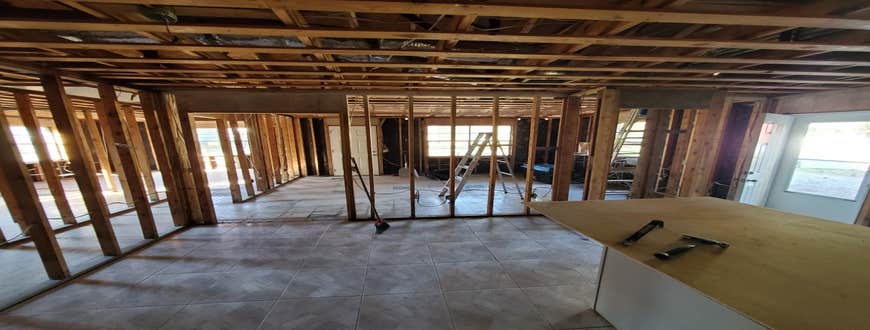 Photos by Service Restoration Pros LLC #1 A tree fell through the roof of this 3 bedroom house during Hurricane Ida. It left several gaping holes a...