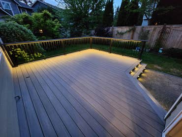 Modern PVC Deck with Integrated LED Stair Lighting This premium low-maintenance deck was built using TimberTech Advanced PVC decking in Coastline with 