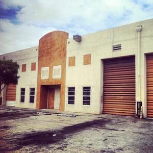 repainting warehouse in Hialeah Pressure washed, one coat of primer two coats of paint