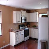 M Fox Builders (Home Remodel) Newly upgraded exterior w/ board and batten vinyl siding and shakes, and kitchen renovation.