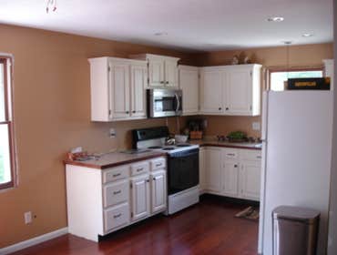 M Fox Builders (Home Remodel) Newly upgraded exterior w/ board and batten vinyl siding and shakes, and kitchen renovation.