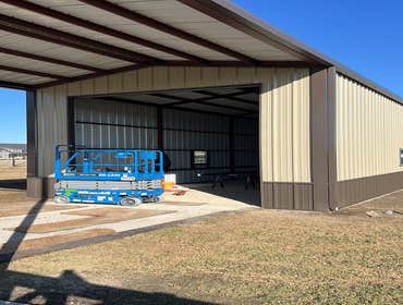 Photos by Paddco LLC #4 Metal shop 20’x45’ with 20’ car port extension, 12’x14’ roll up door and walk-in door.