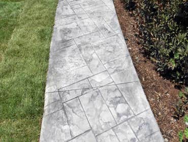 Photos by Stamped Concrete Denver LLC #1 Stamped concrete, often called textured or imprinted concrete, replicates the look of many different stones su