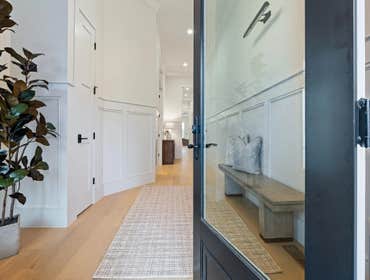Formal foyer with custom paneling, tall ceilings, and bench niche restored by CJMC Build in 12 South, Nashville.