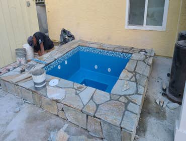 Photos by Gar Builders Inc #5 Remove old spa, install a new larger spa and flagstone surround,