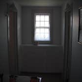 Stone House Remove cabinets and window, add wall closet to bedroom, install sliding door, tile on inside of slider, add secound story deck to front of 