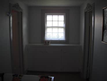 Stone House Remove cabinets and window, add wall closet to bedroom, install sliding door, tile on inside of slider, add secound story deck to front of 