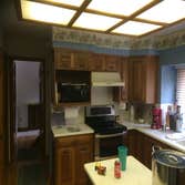 Kitchen Remodel Update kitchen lighting, appliances, and move cabinets to fit new refrigerator