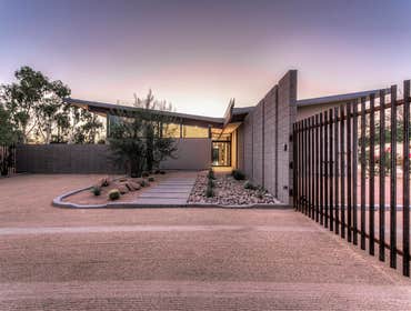 Butterfly House Set near the North base of Camelback Mountain, this home reaches out to capture views and light. A simple butterfly roof floats over th