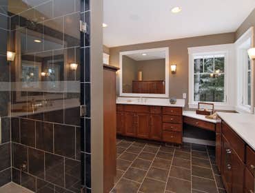 Lockridge Residence This new Transitional Custom Home was built on the owners heavily wooded lot and designed to maintain the woodsy feel while taking 