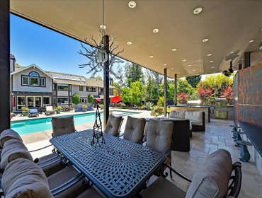 Covered living area with solar. Pool with hot tub, fountain & other landscaping Complete landscape, open living living area, with a kitchen, fireplace,
