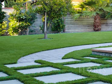 Eagle Rock Project Artificial Turf, Brick path, Privacy hedges, river pebbles, concrete pavers and concrete patio.