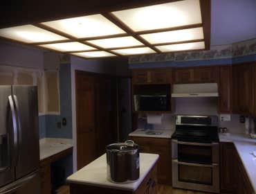 Kitchen Remodel Update kitchen lighting, appliances, and move cabinets to fit new refrigerator