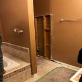 Photos by Griffin Tile & Marble Co #1 Master bath remodel. Remove PVC shower insert , remove separating wall , install new tile shower matching the til