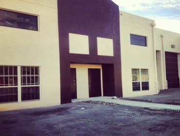 repainting warehouse in Hialeah Pressure washed, one coat of primer two coats of paint