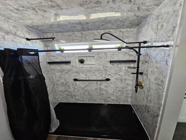 Bath Concepts Acrylic Shower System Replaced old fiberglass unit with new Acrylic Shower System with black fixtures. Life time warranty