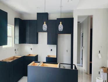 Photos by White Elephant Remodeling LLC #12 All wood soft close cabinets Jet Black with Quartz countertops and island