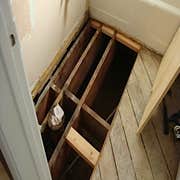 subfloor 1 Rotted subfloor from leak on toilet. Removed to joists, rebuilt to hall floor, linoleum sloped to rise at wall, reinstall all plumbing.
